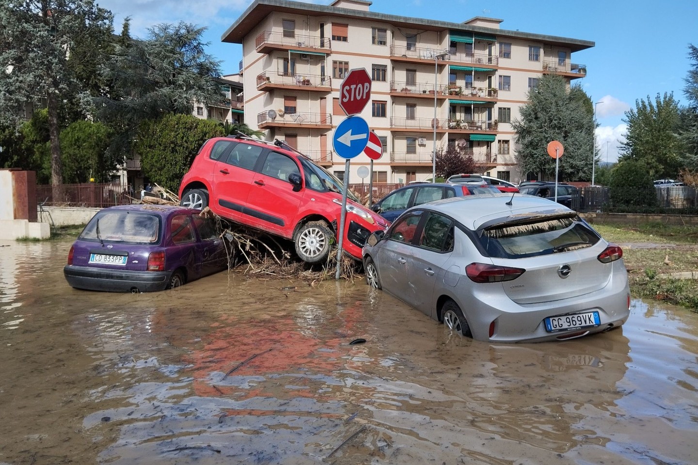 Von den Wassermassen eines Unwetters übereinandergetürmt liegen Autos in den immer noch überfluteten Straßen in Campi Bisenzio.